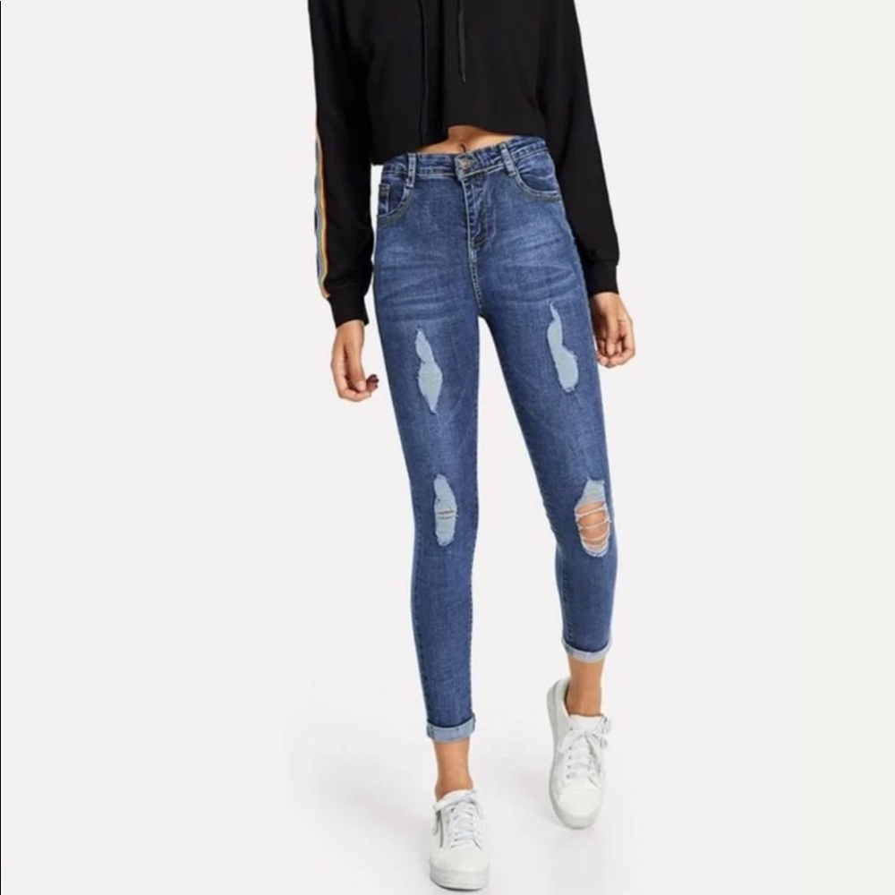 Rolled up distressed denim jeans